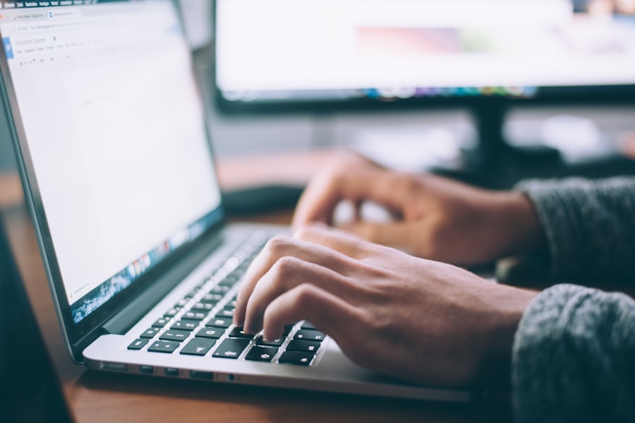 Hands typing on a laptop while working