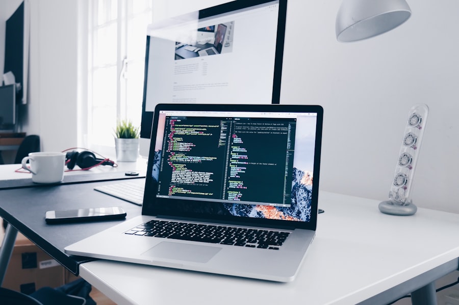Modern software development workspace with laptop and code